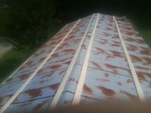 Rusted metal roof panels with new wood purlins before replacement — Storm Damage Roof Repair in Palatka by Roofing Brothers